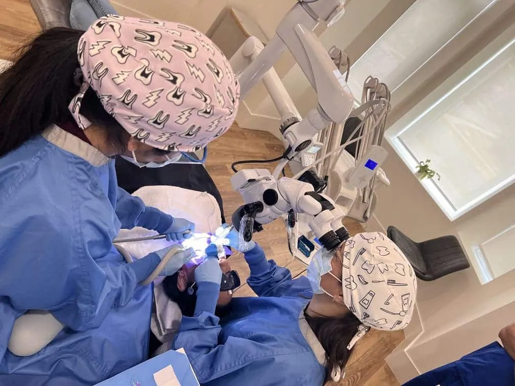 Overhead view of a treatment room with the doctor at the operating microscope